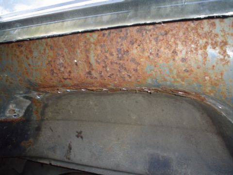 1988 Ford Bronco - The wheel well shows significant rust damage and corrosion.