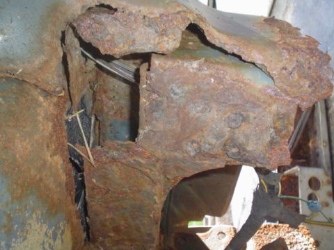 1988 Ford Bronco - Close-up view of severely corroded vehicle bodywork, obscuring specific identification.