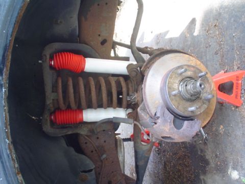 1988 Ford Bronco - The vehicle's front suspension and brake assembly are shown, with new shocks installed.