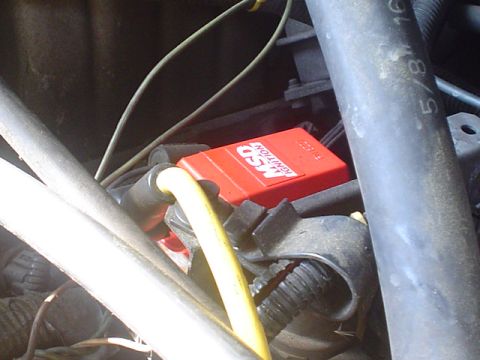 1988 Ford Bronco - Close-up view of engine components, including an MSD ignition box and yellow wiring.