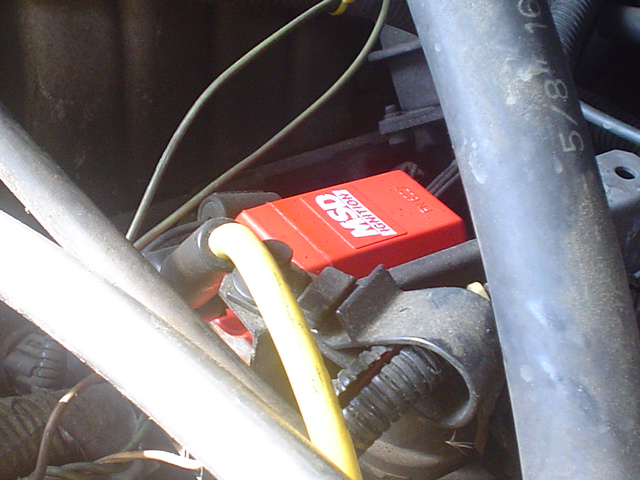 Red MSD ignition box and yellow wire in engine bay