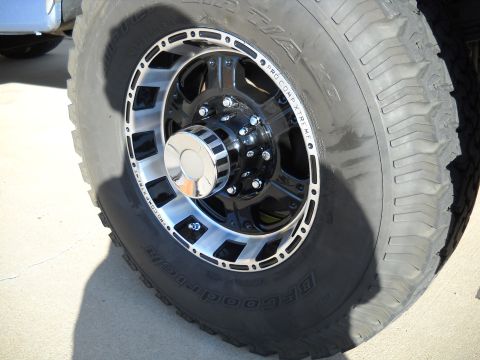 1996 Ford F-250 - Close-up of a heavy-duty truck wheel and tire assembly with custom rims.