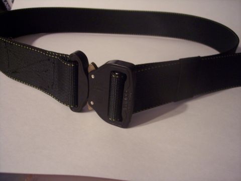 1984 Ford Bronco - A black tactical belt with a cobra buckle is displayed against a light background.