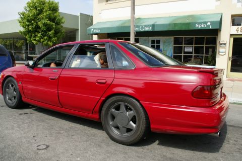1990 Ford Taurus - This 1990 Ford Taurus sedan is captured from the rear three-quarter angle, its distinctive body style.