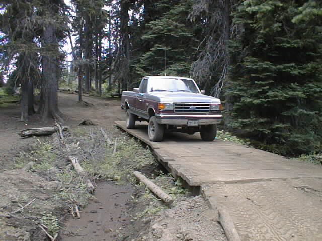 Crossing the bridge at entrance of the trail to Funny Rocks & Moon Rocks play areas.