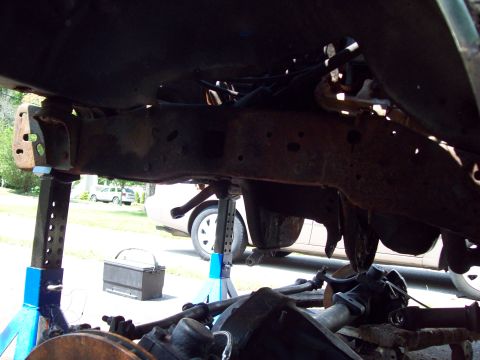 1989 Ford F-150 - Underbody view of a truck's frame and suspension system, with another vehicle in the background.