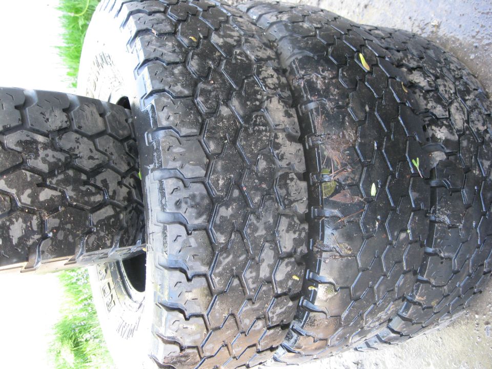 close-up of two large, wet tires with hexagonal tread patterns