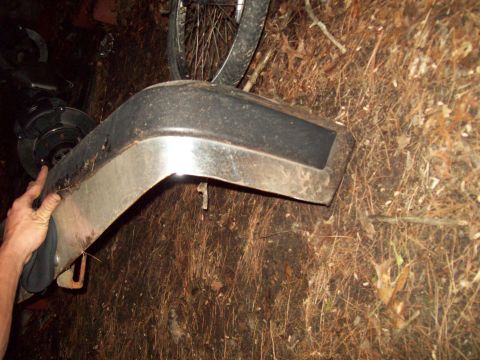 1989 Ford F-150 - This photo shows a bumper, possibly from a 1989 Ford F-150, lying on the ground.