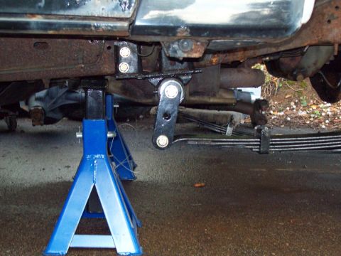 1989 Ford F-150 - Truck frame and suspension parts are supported by jack stands during work. The Supermotors.net logo is visible.