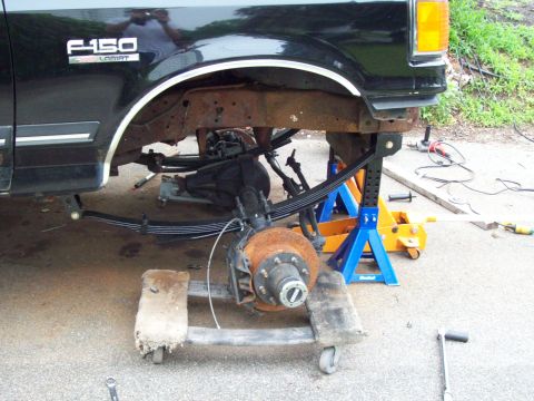 1989 Ford F-150 - The suspension of a 1989 Ford F-150 is disassembled for maintenance.