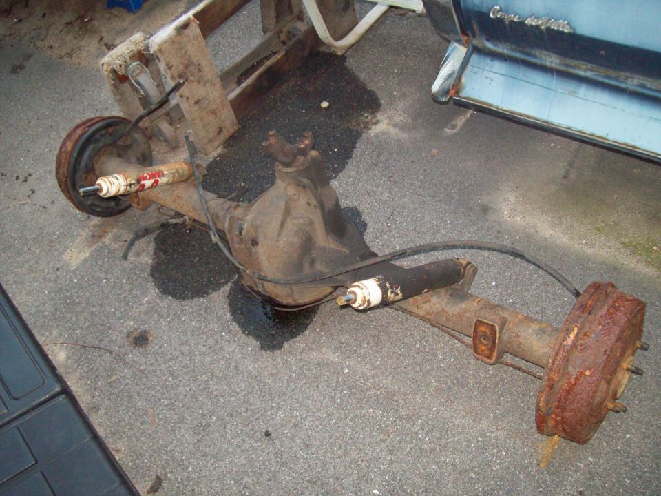 Rusty rear axle assembly with drum brakes and shock absorber