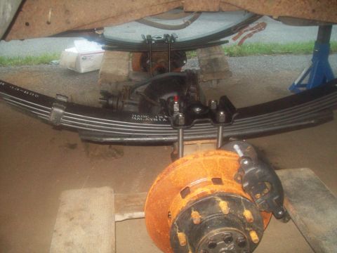 1989 Ford F-150 - Close-up view of truck rear axle and suspension components, showing brake assembly and leaf springs.