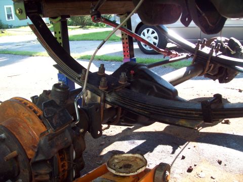 1989 Ford F-150 - Close-up view of a truck's rear suspension and axle components during maintenance.