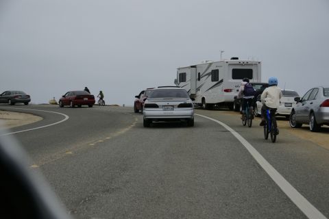 1990 Ford Taurus - Silver 1990 Ford Taurus driving on a road with other cars, cyclists, and an RV nearby.