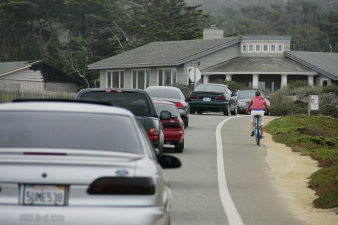 1990 Ford Taurus - Silver 1990 Ford Taurus seen from the rear in a line of traffic on a coastal road.