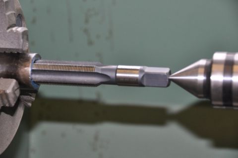 1996 Ford Bronco - A tap is being centered in a lathe chuck, with a live center supporting the other end.