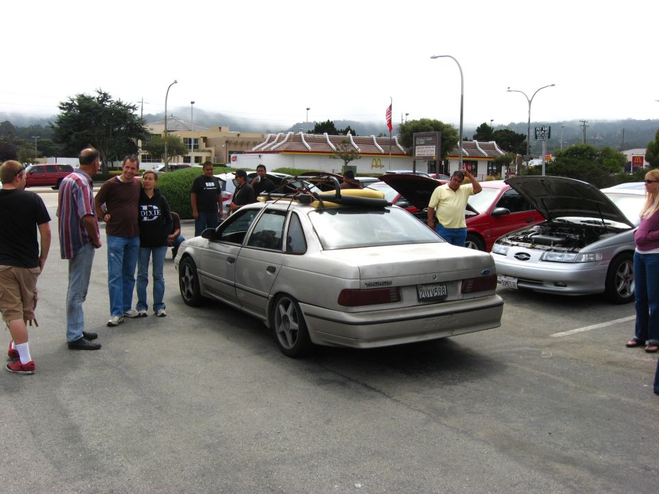 Silver sedan with roof rack, rear view. License plate reads PGY598