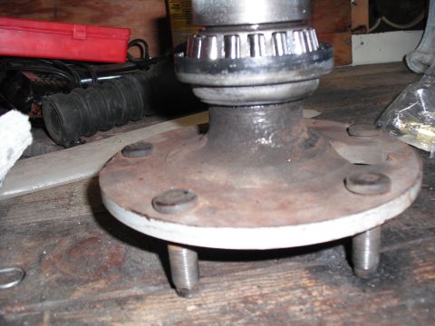 1991 Ford Bronco - A close-up view of a used wheel hub assembly, showing signs of wear and rust.