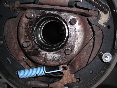 1991 Ford Bronco - A close-up view of a vehicle's brake drum assembly, showing various components including springs and brake shoes.