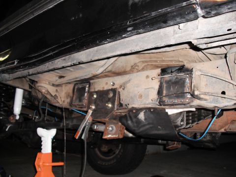 1991 Ford Bronco - Custom frame sliders are being welded onto the chassis of a vehicle, indicating modifications for off-road use.