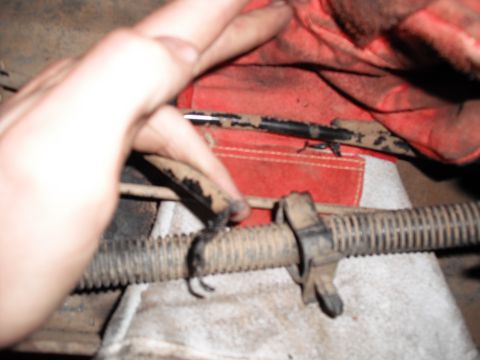 1991 Ford Bronco - A close-up view of a ribbed hose and clamp, likely part of a vehicle's undercarriage.