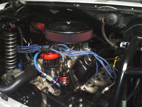1984 Ford Bronco - Close-up view of a V8 engine bay, showing various components and wiring.