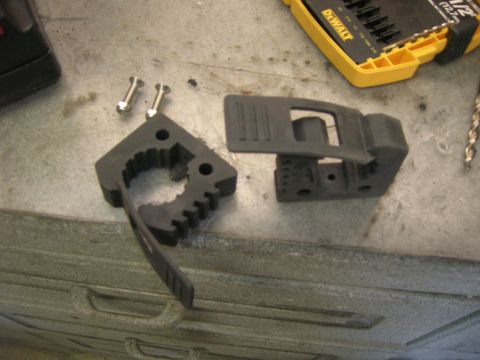 1996 Ford Bronco - Parts for a tool mount are laid out on a workbench next to a drill bit case.