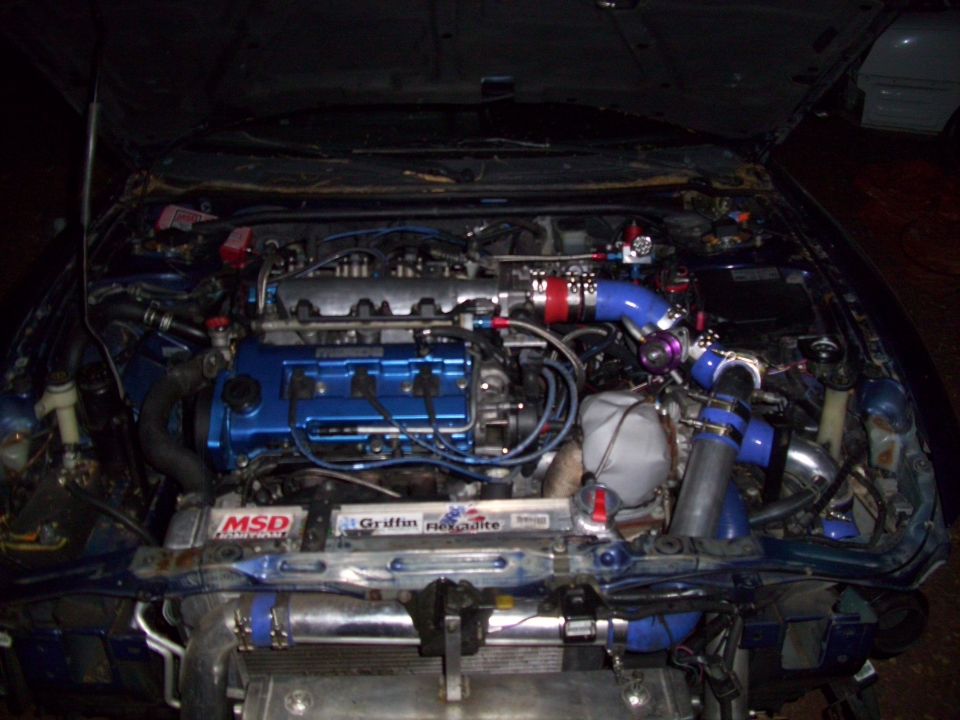 Engine bay with blue engine covers and turbocharger components. MSD and Griffin labels visible