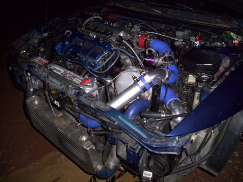 Turbocharged engine bay with blue hoses and intercooler