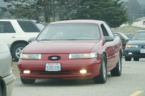 1990 Ford Taurus - Red 1990 Ford Taurus with California plates 5ZDS335 is seen in traffic.
