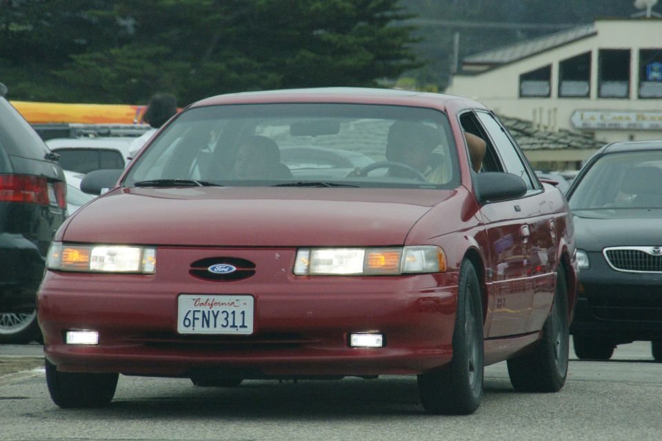 Red Ford Taurus with California license plate 6FNY311, seen from the front