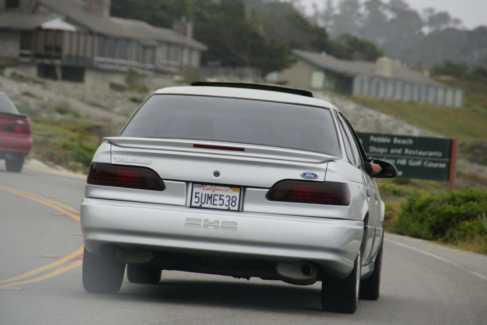 Silver 1990 Ford Taurus rear view with California license plate 5UME538