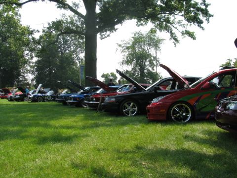 2003 Mercury Marauder - Several cars are parked on a lawn with their hoods open, suggesting a car show or exhibition.