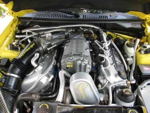2003 Mercury Marauder - The engine bay displays a supercharged Ford SVT engine with a prominent cobra emblem and "Supercharged" text.
