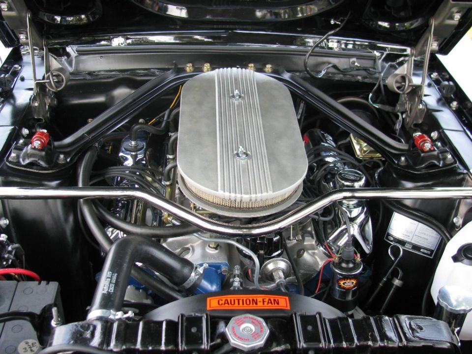 Engine bay with chrome air cleaner and "CAUTION-FAN" sticker
