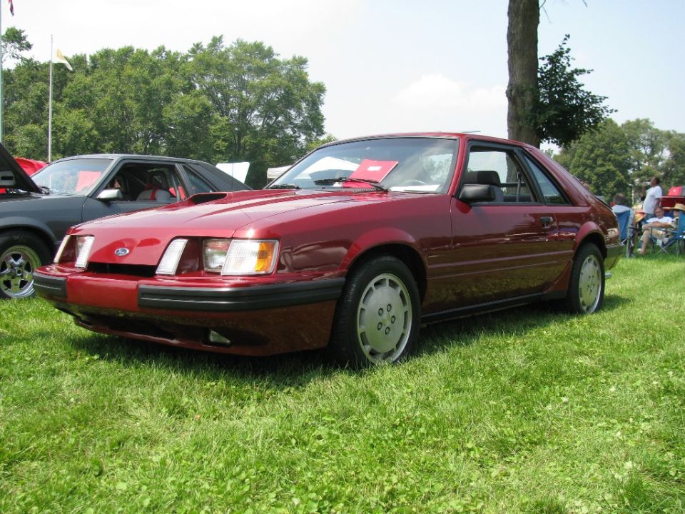 Red Ford Mustang SVO hatchback at a car show