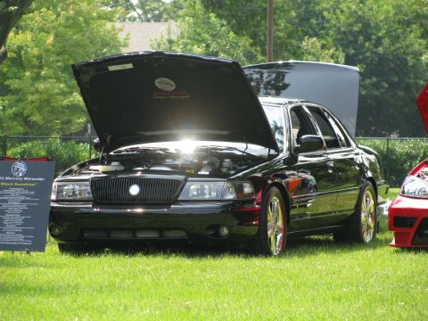 2003 Mercury Marauder - Black 2003 Mercury Marauder on display with its hood open, showing the engine bay.
