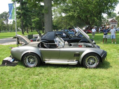 2003 Mercury Marauder - A silver Shelby Cobra replica is displayed with its hood and trunk open at an outdoor car show.