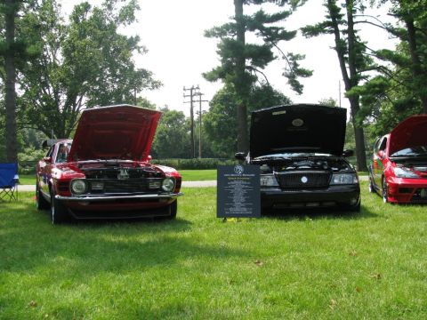 2003 Mercury Marauder - A black 2003 Mercury Marauder is displayed with its hood open at an outdoor car show.