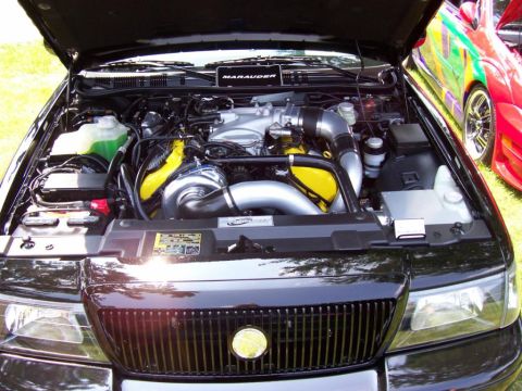 2003 Mercury Marauder - The engine bay of a 2003 Mercury Marauder features a prominent turbocharger and custom yellow engine components.