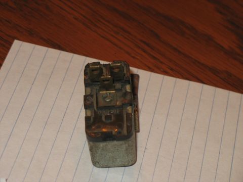 1979 Ford Bronco - This electrical relay has visible metal terminals and a grey casing, likely a replacement part.
