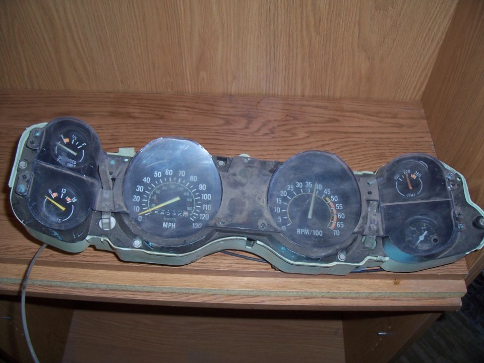 Car dashboard gauges with speedometer, tachometer, oil pressure, and voltage meters