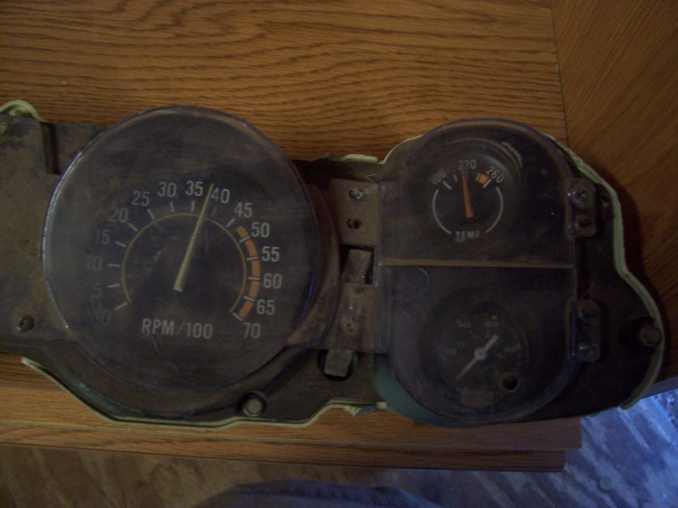 Tachometer and temperature gauge from a vehicle dashboard