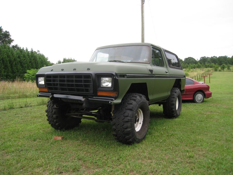 Green lifted 1979 Ford Bronco with black grille and large tires