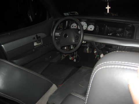 1999 Ford Crown Victoria - Interior view of a 1999 Ford Crown Victoria, including dashboard and seats.