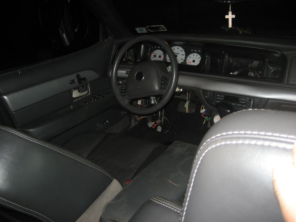 1999 Ford Crown Victoria interior showing dashboard, steering wheel, and seats