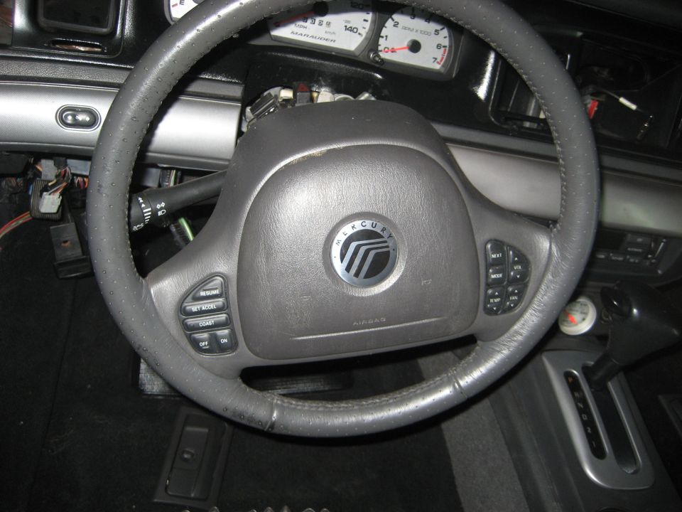 Gray Mercury steering wheel and Marauder gauge cluster with dash partly disassembled