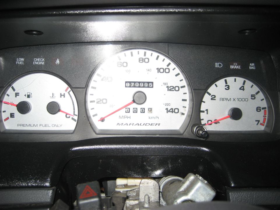 White-face gauge cluster reading 70,995 miles with MARAUDER speedometer, trim removed
