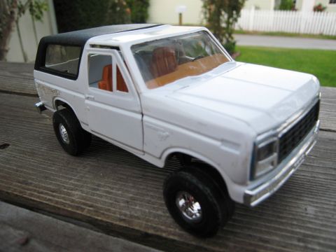 1986 Ford Bronco - Diecast model of a 1986 Ford Bronco, photographed outdoors on a wooden deck.