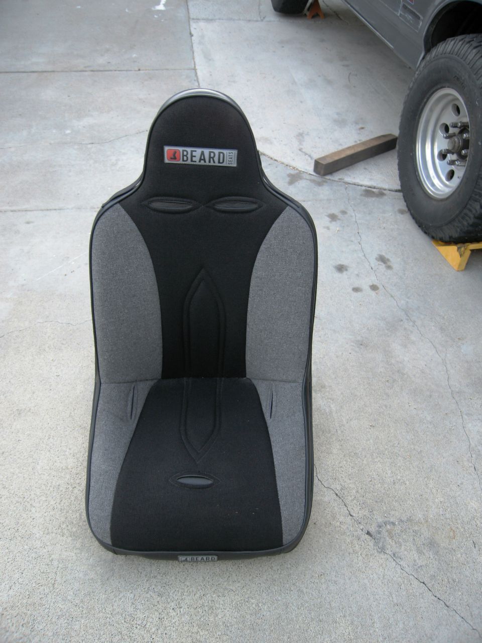 Black and gray racing seat with a BEARD logo on top